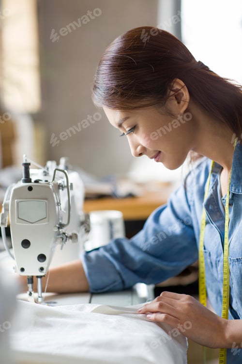 Preview: Fashion designer using sewing machine