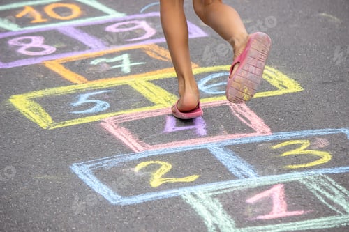 Preview: little girl plays hopscotch. selective focus