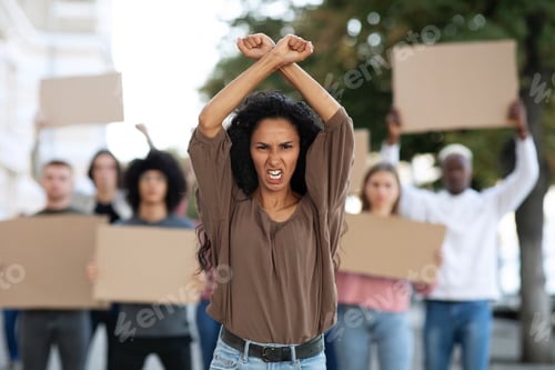 Preview: Angry woman leading group of protestors on the street