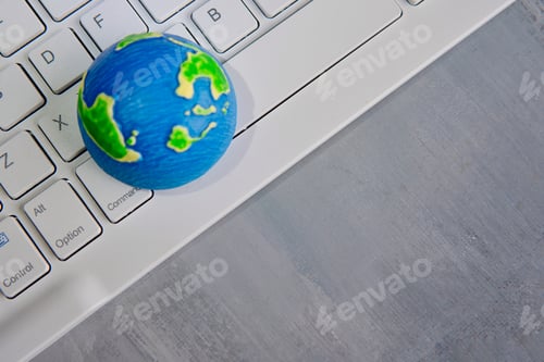 Preview: A globe on a white computer keyboard with copy space.