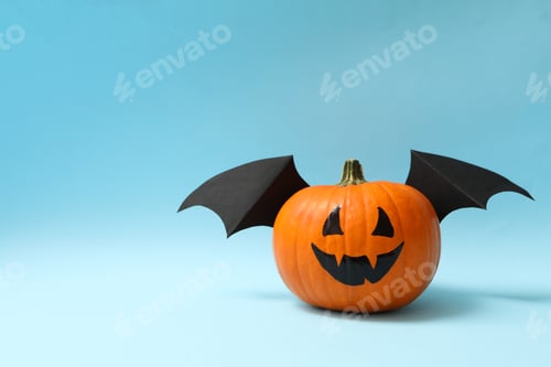 Preview: Pumpkin with smile and wings on blue background