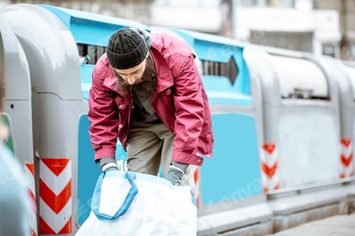 Preview: Homeless beggar with bag near the trash in the city