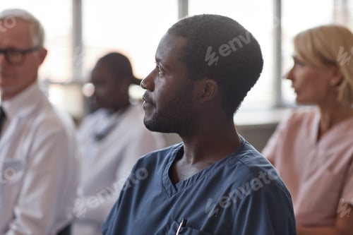 Preview: Profile of Black Man Attending Lecture in Conference Room of Hospital
