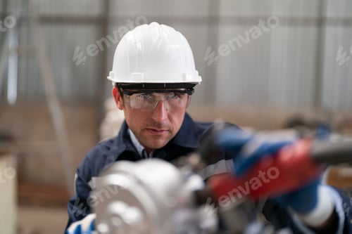 Preview: Robotics engineer operating robot aided CNC machine in robotics research facility