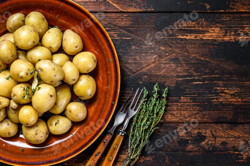 Preview: New young boiled potato with butter and chopped dill. Dark Wooden background. Top view. Copy space