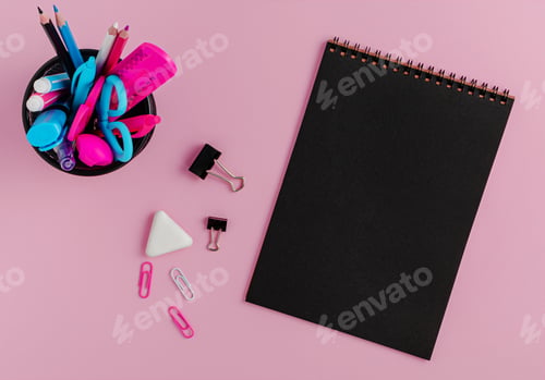 Preview: Black empty notebook blank, colorful stationery on pink background. Flat lay, copy space