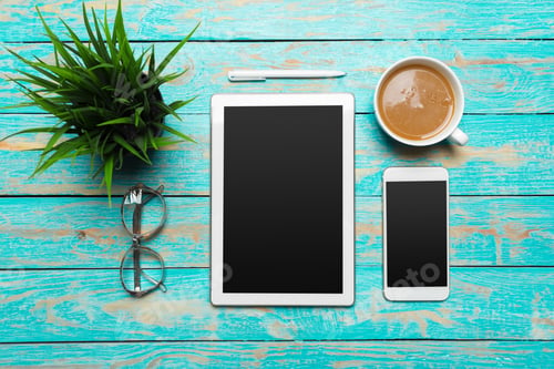 Preview: digital tablet and coffee cup on wooden table