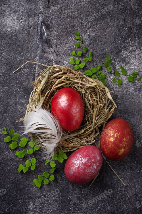Preview: Easter painted red eggs on nest