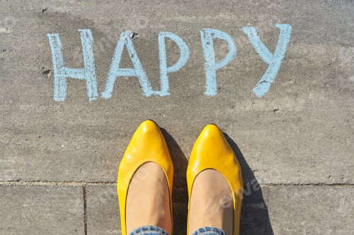 Preview: Happy concept, top view on woman legs and text written in chalk on gray sidewalk