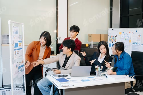 Preview: Group of diverse businesspeople using a laptop and tablet in office.