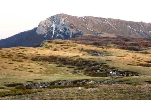 Preview: Top view of a picturesque hill covered with grass