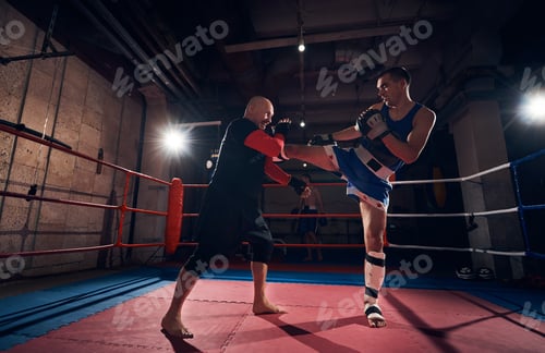 Preview: Boxers training kickboxing in the ring at the health club