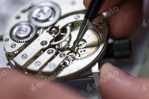 Preview: Closeup shot of a craftsman fixing gears on a clock