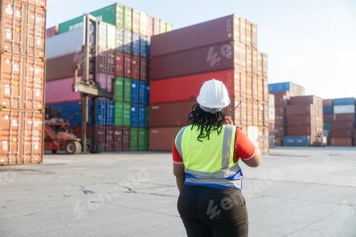 Preview: Female logistics worker communicating at container yard