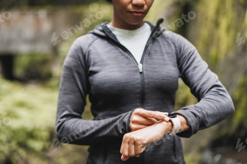 Preview: Black Woman Looking At Smartwatch