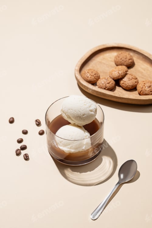 Preview: Affogato coffee with vanilla ice cream scoops and espresso in a glass on a yellow background
