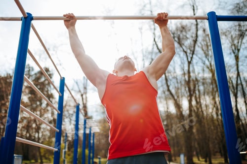 Preview: Outdoor Gym Workout Young Male Athlete Performing Pull-Ups on a Bar