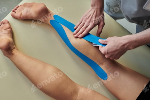 Preview: Applying Kinesiology Tape on Patient's Leg in Clinic