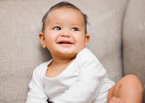 Preview: Shot of an adorable baby girl sitting on the couch at home