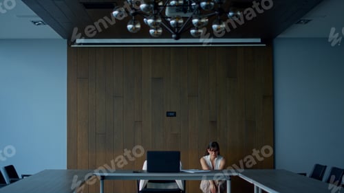 Preview: Sad freelancer looking solution in office. Thoughtful woman walking meeting room