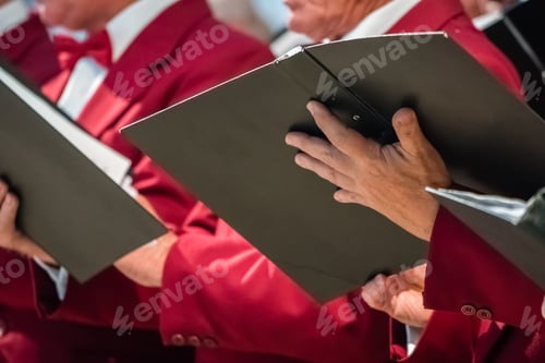 Preview: Mens choir members holding singing book