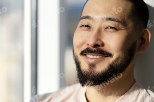 Preview: Closeup, portrait of an attractive smiling Asian man. Cheerful guy looking at camera, copy space.