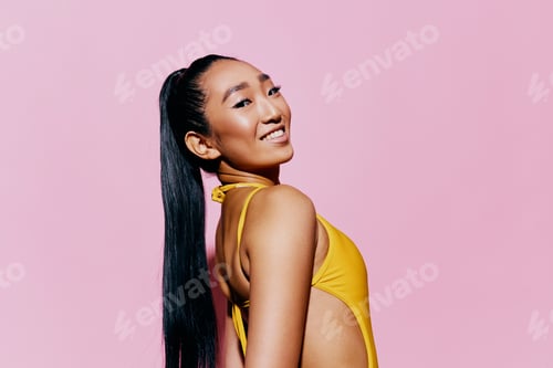 Preview: Beautiful Woman in Yellow Posing Against Pink Background