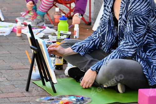Preview: Woman doing a Plein Air painting on the sidewalk of the historic downtown Main Street