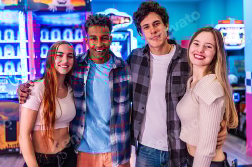 Preview: Happy multiethnic friends enjoying time together at the arcade