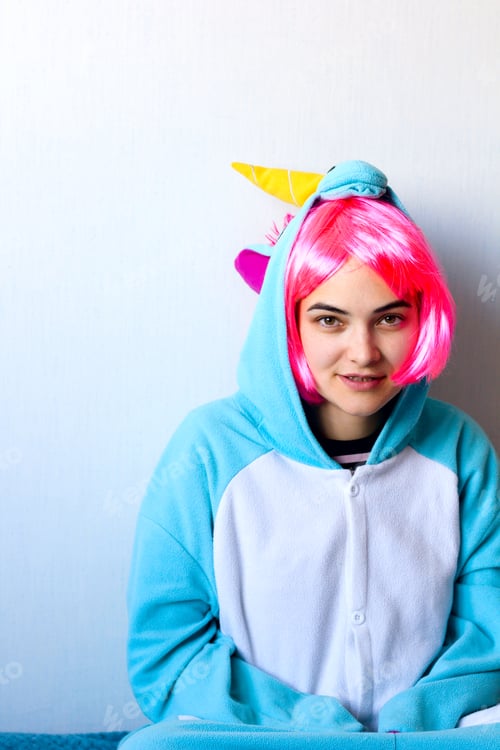 Preview: cute girl in a pink wig in kigurumi unicorn pyjamas costume