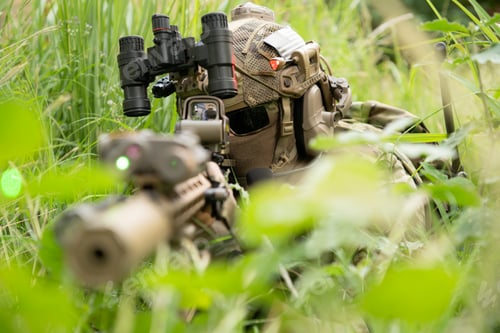 Preview: Special forces soldier in camouflage with a pair of weapons that are full of modern technology