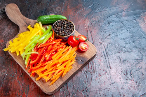 Preview: bottom view colorful cut peppers black pepper tomatoes cucumber on choppingboard on dark red table