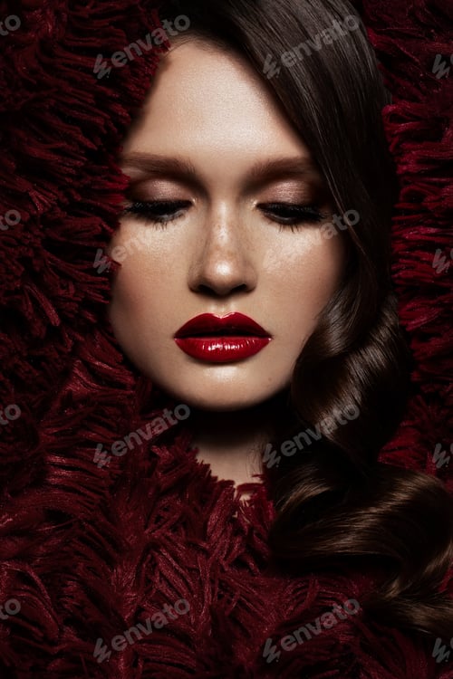 Preview: A beautiful girl with evening make-up, a curls wave and red lips. Beauty face.