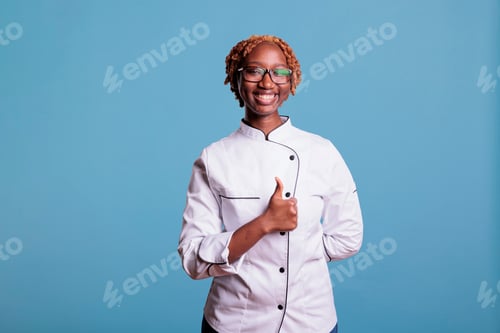 Preview: Curly haired female chef in agreement with peers