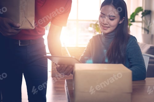 Preview: Courier Delivering Package to client and woman receive parcel box and signing document