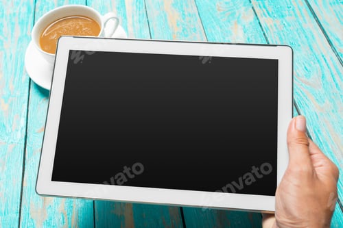 Preview: digital tablet and coffee cup on wooden table