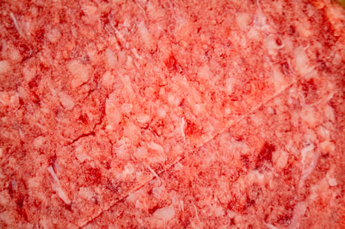 Preview: Raw burger. Macro background. The texture of the raw burger.
