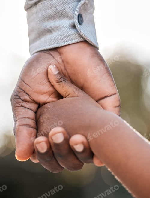 Preview: Closeup shot of a father holding his sons hand while walking together outdoors