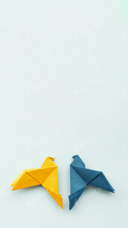 Preview: two doves origami paper in yellow and blue colors of Ukrainian flag on background, vertical, 16:9