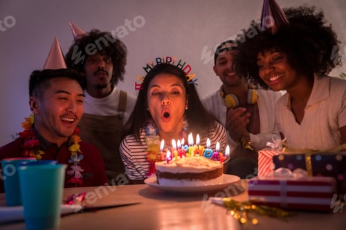 Preview: birthday party on the sofa home with a cake and gifts, blowing out the candles with the lights off