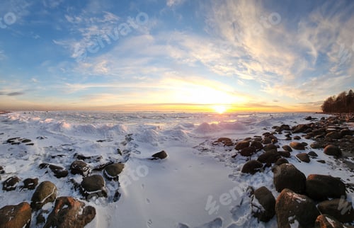 Preview: Winter landscape. Panoramic view of beautiful sunset on bay. List clouds over water in bright light