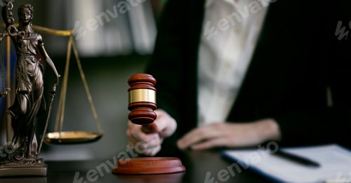Preview: justice and law concept. Closeup judge hand holding gavel in a courtroom.