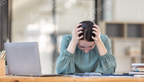 Preview: Portrait of tired young business american woman work with documents tax laptop computer in office.