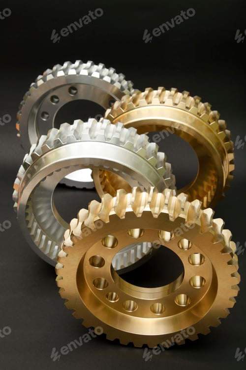 Vista previa: Steel and copper gears on a black background.