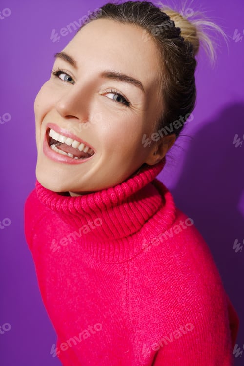 Preview: Wide-angle portrait of cheerful woman wearing warm polo neck sweater against purple background