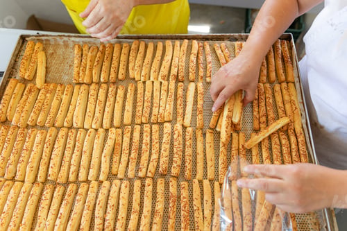 Preview: Patisserie packs fresh breadstick taken out of the oven.