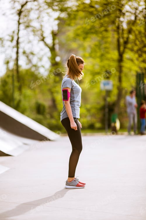 Preview: Young woman having exercise in the park