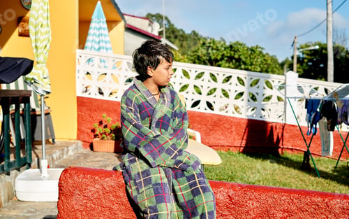 Preview: pensive boy in a bathrobe in summer