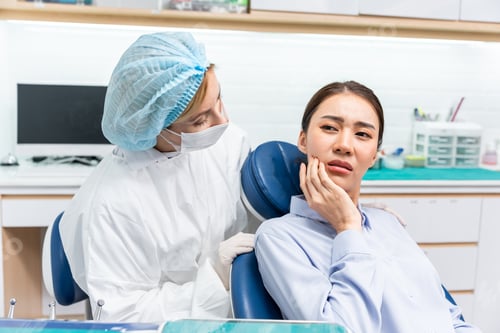 Preview: Caucasian dentist examine tooth for young girl at dental health clinic.