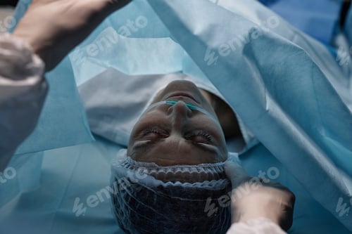 Preview: Top View of Woman Lying on Operating Table